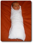 Swaddled baby, photo by Produnis, available through Creative Commons